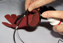 Spray inside of red glove with conductive spray